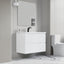 Modern bathroom with white vanity, mirror, and toilet against a gray wall.