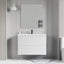 Bathroom vanity with mirror and towel rack against a gray wall.