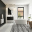 Modern bathroom with freestanding bathtub, patterned floor, and large window.