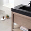 Bathroom vanity with black countertop and wooden cabinet