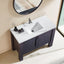 Bathroom vanity with white countertop, sink, and dark wood base.