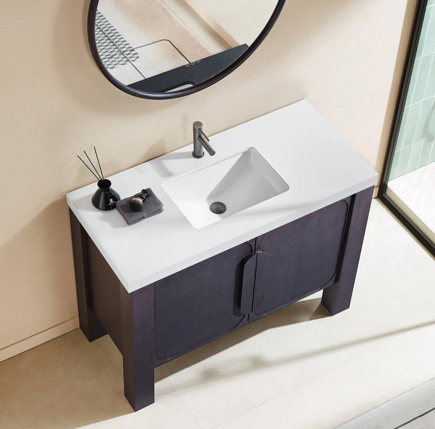 Bathroom with wooden vanity, white countertop, and decorative elements.