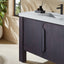 Bathroom vanity with dark cabinets, white countertop, and sink.