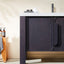 Bathroom vanity with dark wood finish and white countertop, featuring a towel and toiletries.