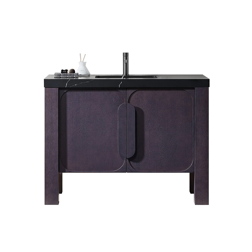 Bathroom with wooden vanity, white countertop, and decorative elements.