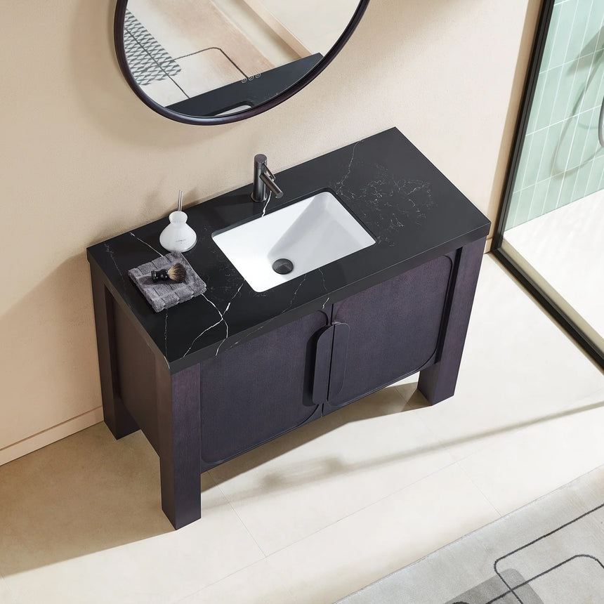 Bathroom with wooden vanity, white countertop, and decorative elements.