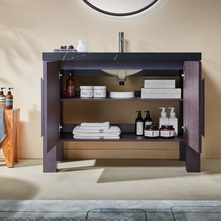 Bathroom with wooden vanity, white countertop, and decorative elements.