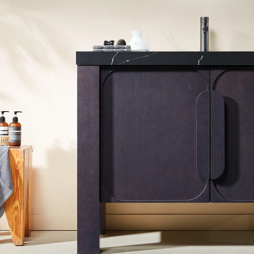 Bathroom with wooden vanity, white countertop, and decorative elements.