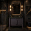 Modern bathroom with dark vanity, mirror, and decor