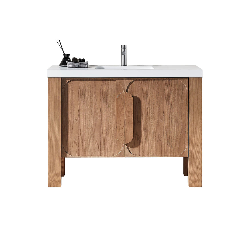 Bathroom with wooden vanity, white countertop, and decorative elements.