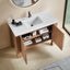 Bathroom vanity with open cabinet, sink, and toiletries on a beige floor.