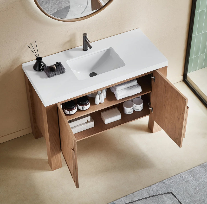 Bathroom with wooden vanity, white countertop, and decorative elements.