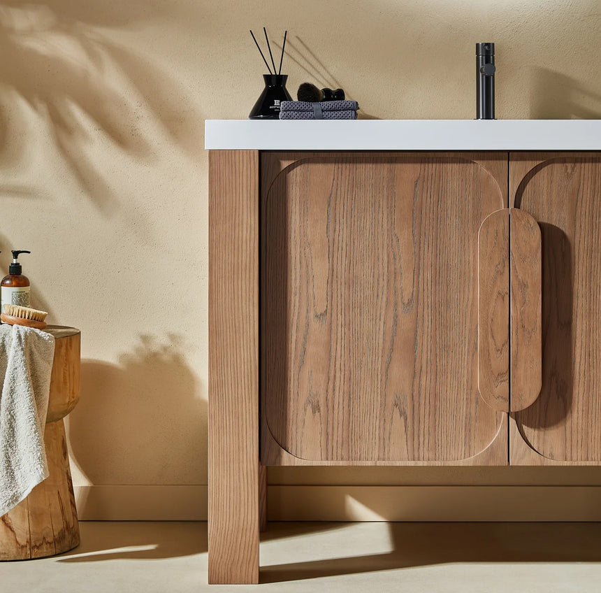 Bathroom with wooden vanity, white countertop, and decorative elements.