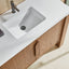 Bathroom vanity with white sink and wooden cabinets