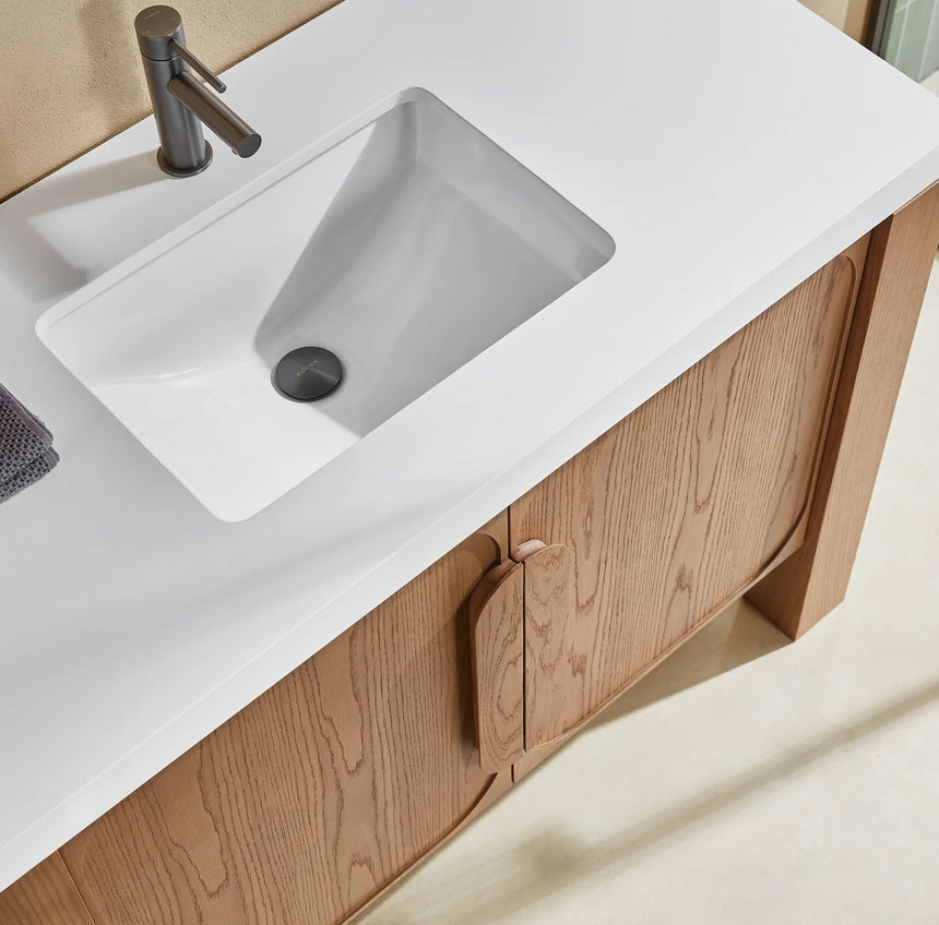 Bathroom with wooden vanity, white countertop, and decorative elements.