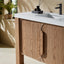 Bathroom vanity with wooden cabinets, white countertop, and black faucet.