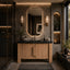 Modern bathroom with wooden vanity, mirror, and decorative elements.