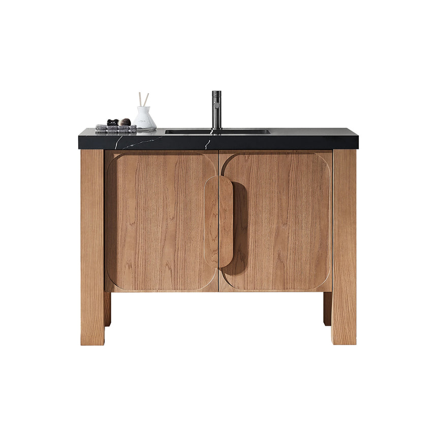 Bathroom with wooden vanity, white countertop, and decorative elements.