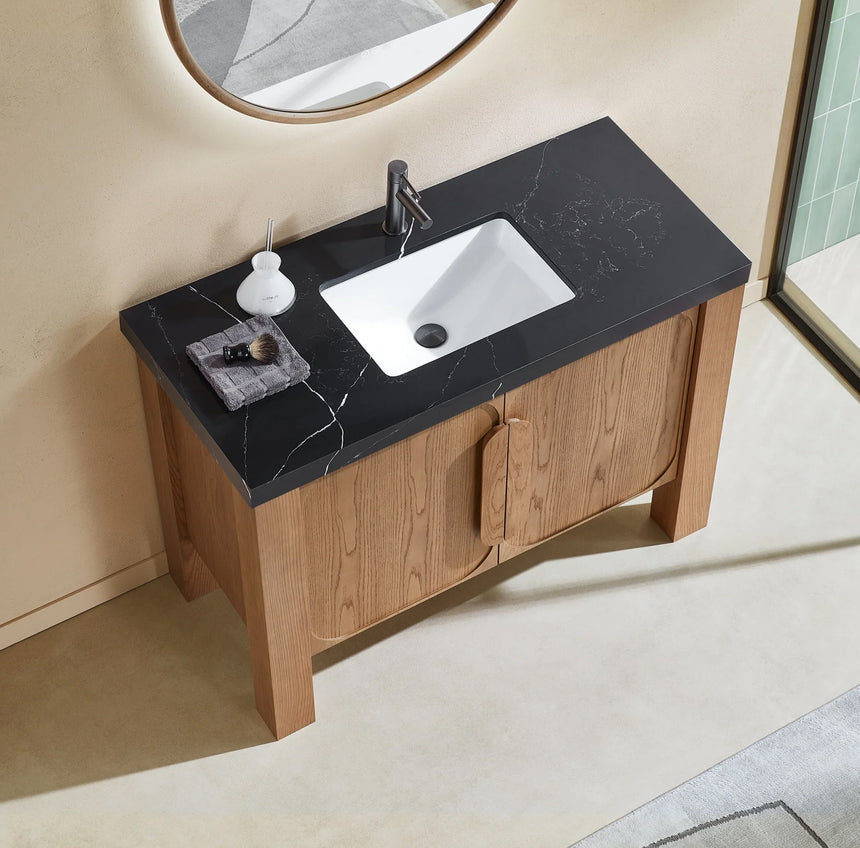 Bathroom with wooden vanity, white countertop, and decorative elements.