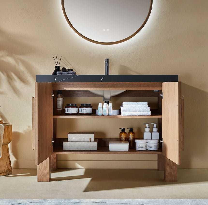Bathroom with wooden vanity, white countertop, and decorative elements.