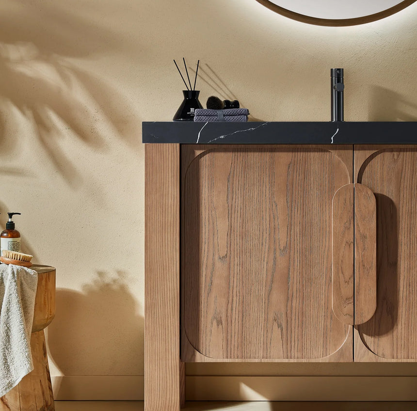 Bathroom with wooden vanity, white countertop, and decorative elements.