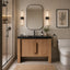 Modern bathroom with wooden vanity, mirror, and toilet.