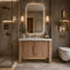 Modern bathroom with wooden vanity, illuminated mirror, and decorative elements.