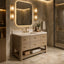 A modern bathroom vanity with a light wood cabinet, white countertop, and gold faucet, set in a luxurious bathroom with marble walls and a lit rectangular mirror.