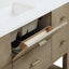 Wooden bathroom vanity with open drawer and white countertop