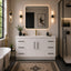 Modern bathroom with white vanity, mirror, and bathtub.