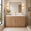 Modern bathroom with wooden vanity, mirror, and decorative elements.