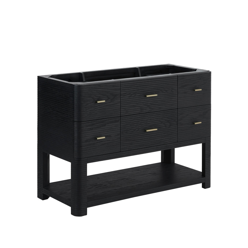 A modern bathroom vanity with a light oak wood frame, six drawers, an open lower shelf, and a white marble top with an integrated sink. The vanity is styled in a bright bathroom with a white freestanding tub, a gold faucet, and a glass shower stall in the background.