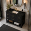 A modern bathroom vanity featuring a black textured wood cabinet with gold handles, a dark green marble countertop, a white rectangular sink, and a gold faucet, set against a marble wall.