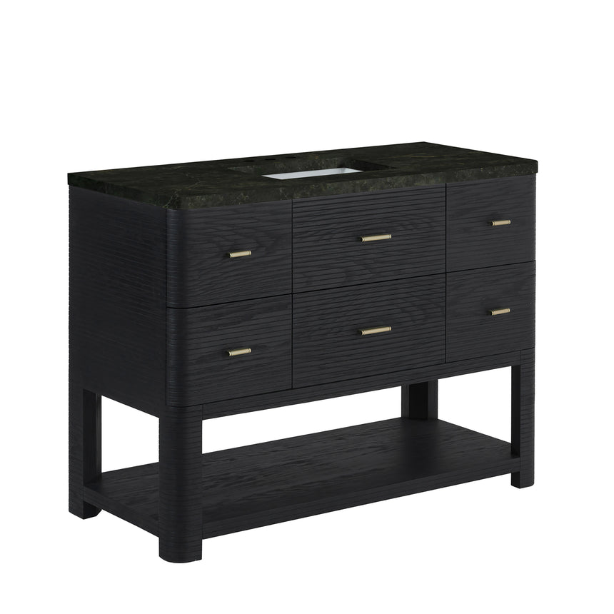 A modern bathroom vanity with a light oak wood frame, six drawers, an open lower shelf, and a white marble top with an integrated sink. The vanity is styled in a bright bathroom with a white freestanding tub, a gold faucet, and a glass shower stall in the background.