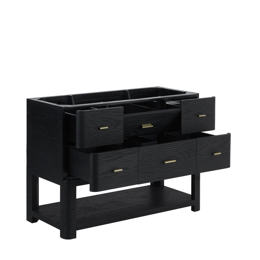 A modern bathroom vanity with a light oak wood frame, six drawers, an open lower shelf, and a white marble top with an integrated sink. The vanity is styled in a bright bathroom with a white freestanding tub, a gold faucet, and a glass shower stall in the background.
