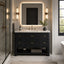 A modern bathroom vanity with a dark charcoal textured cabinet, a white marble countertop, and gold hardware, set in a contemporary bathroom with a backlit mirror and wall sconces.