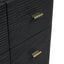 Close-up of a black ribbed wooden cabinet or dresser with two brass-toned cylindrical drawer pulls on a white background.