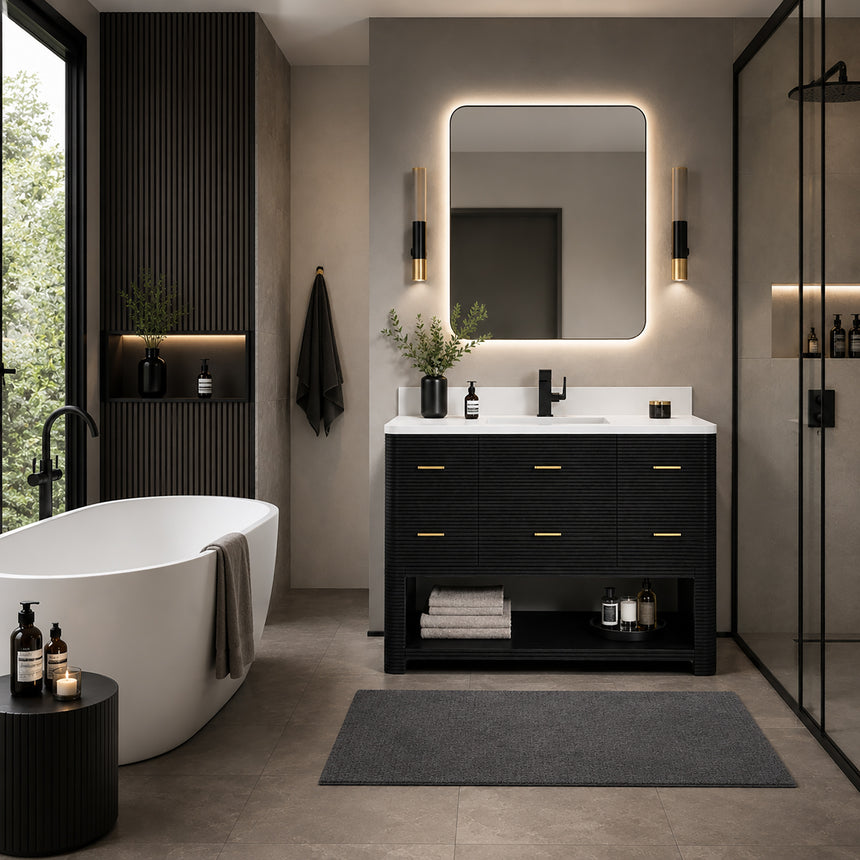 A modern bathroom vanity with a light oak wood frame, six drawers, an open lower shelf, and a white marble top with an integrated sink. The vanity is styled in a bright bathroom with a white freestanding tub, a gold faucet, and a glass shower stall in the background.