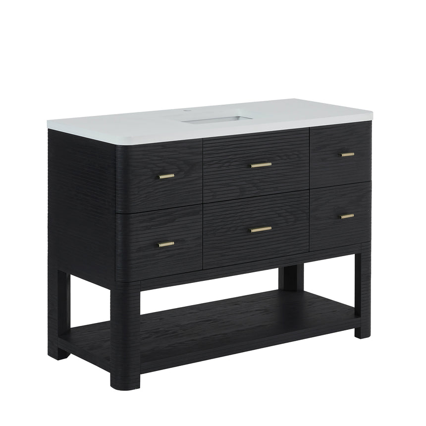 A modern bathroom vanity with a light oak wood frame, six drawers, an open lower shelf, and a white marble top with an integrated sink. The vanity is styled in a bright bathroom with a white freestanding tub, a gold faucet, and a glass shower stall in the background.