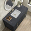 Bathroom vanity with dark marble countertop, white sink, and gold fixtures.