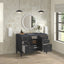 Bathroom vanity with open cabinet doors, round mirror, and decorative items.