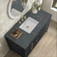 Bathroom vanity with dark marble countertop, white sink, and decorative elements.