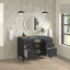 Bathroom vanity with open cabinet doors, round mirror, and decorative items.