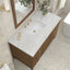 Bathroom vanity with marble countertop, wooden cabinets, and decorative elements.