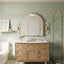 48 inch Bathroom vanity, with round mirror, and green tiled walls.