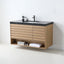 A modern wall-mounted bathroom vanity with a light oak wood slat cabinet, open lower shelf, black stone countertop, and a black sink with a matte faucet, shown against a white wall.