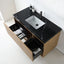Modern wall-mounted bathroom vanity with a black marble-look countertop, white integrated sink, black faucet, and light wood cabinet with open drawers shown.