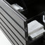 Close-up of a dark gray drawer front with a slatted modern design, partially open to reveal white storage bins and boxes inside.