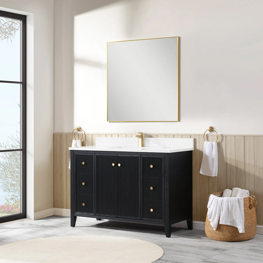 Bathroom vanity with double sink, mirrors, and towels in a well-lit room.