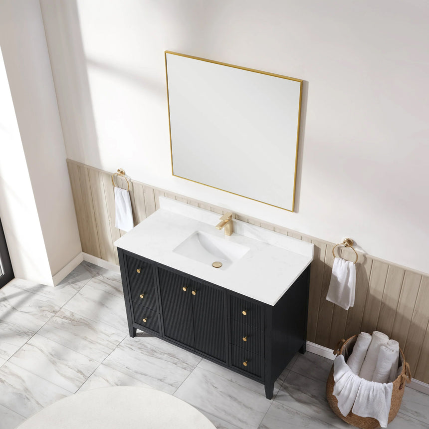 Bathroom vanity with double sink, mirrors, and towels in a well-lit room.